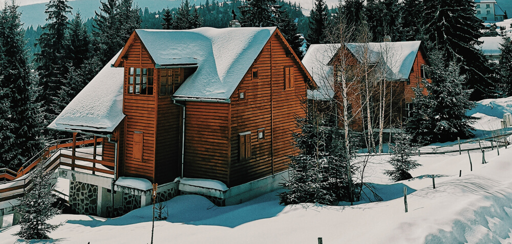 Cabin in the mountains covered in Snow